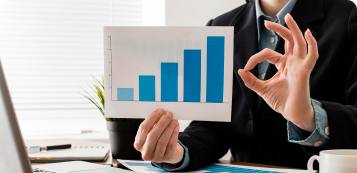 businessman-doing-ok-sign-while-holding-growth-chart-1.png